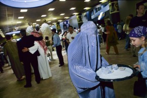 31-Woman in burqa serves peanuts